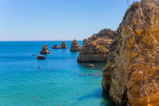 Lagos, Portugal - 25 August 2025: Tourists visiting Ponta da Piedade, in Lagos. Algarve, Portugal