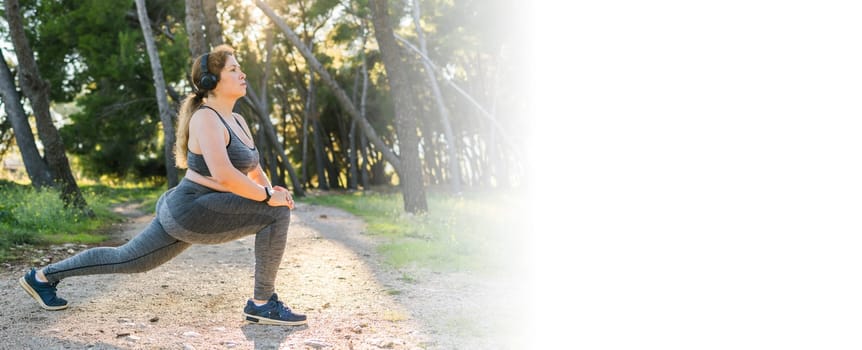 Adorable fat woman in tracksuit is engaged in fitness outdoor side view portrait. Young overweight woman lunges outdoors on warm summer day. Healthy lifestyle and weight loss.