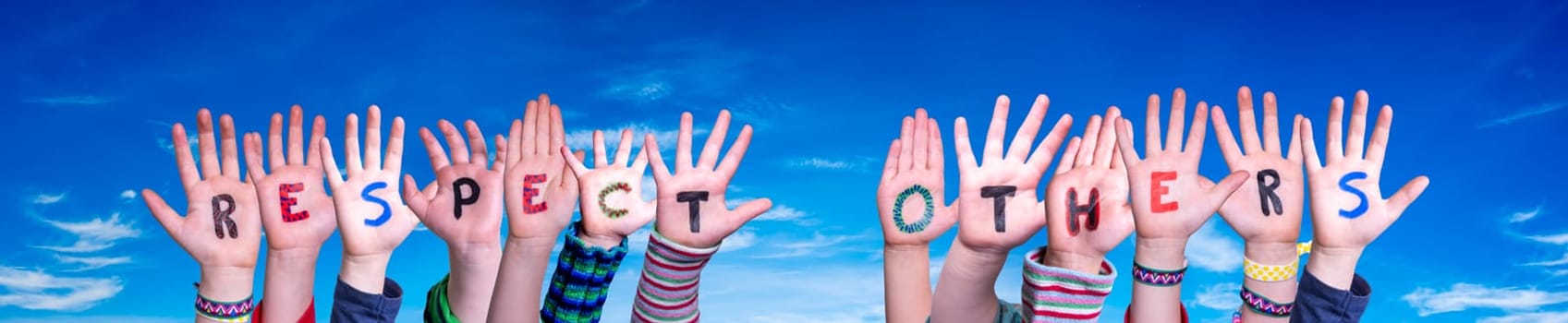 Children Hands Building Colorful English Word Respect Others. Blue Sky As Background.