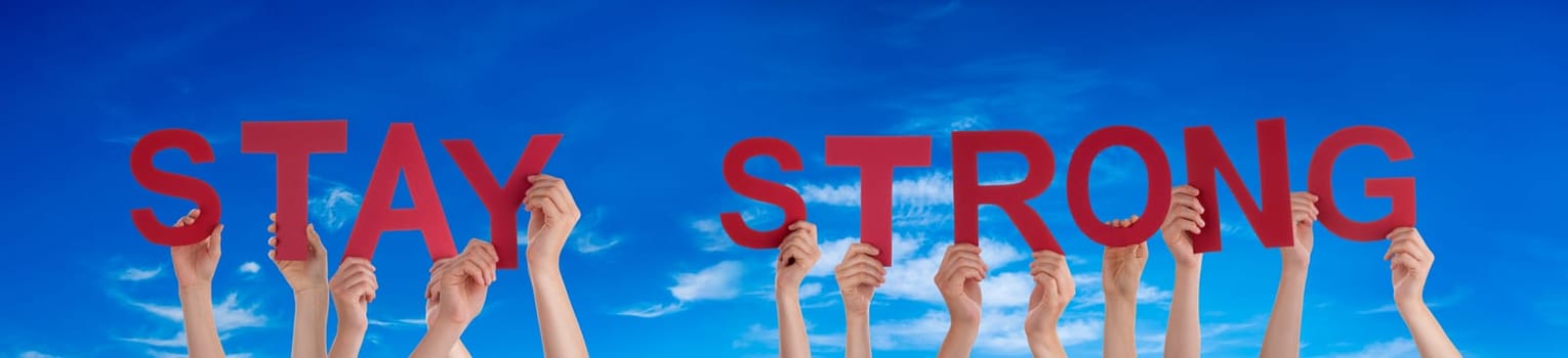 People Or Persons Hands Building English Word Stay Strong. Summer Ocean, Sea And Beach As Background.