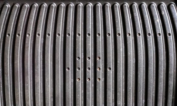 Black electric grill grate, textured background. The surface of the electric grill. Pollution of the surface of the electric stove. Close-up of a home electric grill, in the kitchen. BBQ