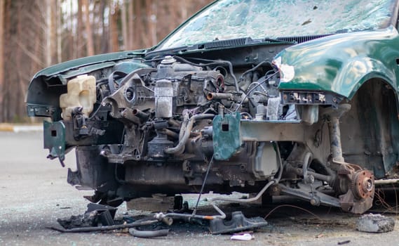 Broken crumpled car after a severe accident with a skewed body, after a powerful impact on the side of the road. Traffic accident on the street, damaged car after a collision in the city