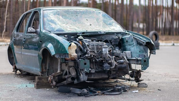 Broken crumpled car after a severe accident with a skewed body, after a powerful impact on the side of the road. Traffic accident on the street, damaged car after a collision in the city