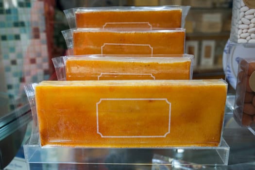 Burnt Egg Yolk Nougat or torro de gema cremada. Traditional catalan pastry specialty displayed at gothic quarter shop