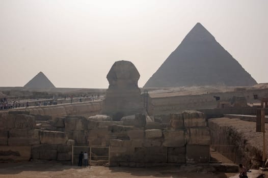 Giza, Egypt - April 13 2008: Sphinx and pyramids (Cheops and Khafre) in the archeological site of Giza. Egypt.