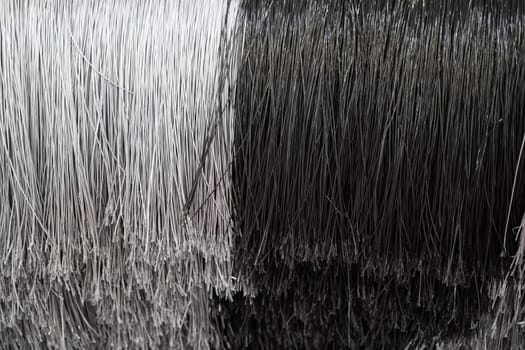 detail of black and white automatic car wash system cleaning fiber polyethylene sponge brushes on spinning rotor