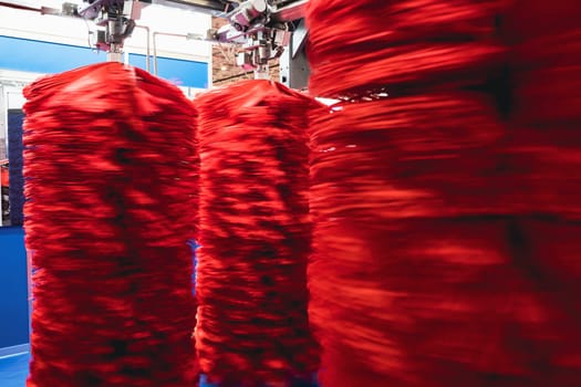 detail of an automatic car wash system in cleaning station with large red textile cleaning brushes rotating with motion blur