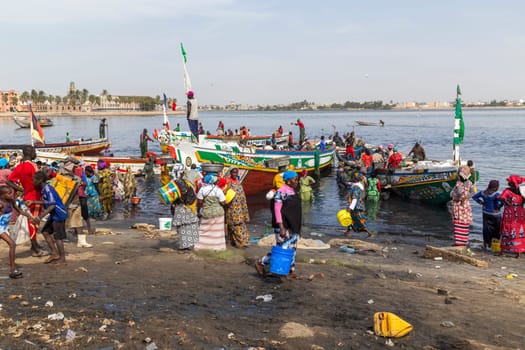 MBour, Senegal: August 18, 2019: Unidentified Senegalese men and women at the fish market in the port city near Dakar.