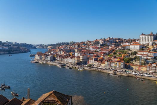 Porto, Portugal - March 02, 2023: View of Ribeira historical quarter on the margin Douro river embankment in the old town and Luis I bridge, Porto, Portugal.
