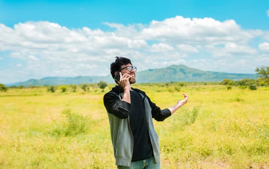 Happy people talking on the cell phone in the field. Man calling on the phone in the field, A man in a countryside talking on the phone, Smiling man calling on the phone on the field