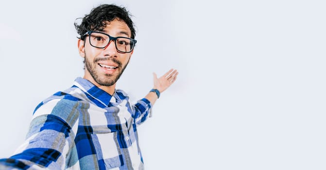 Man pointing back and presenting a product, Young man welcoming you isolated, person welcoming you with one hand. Friendly man inviting you to come