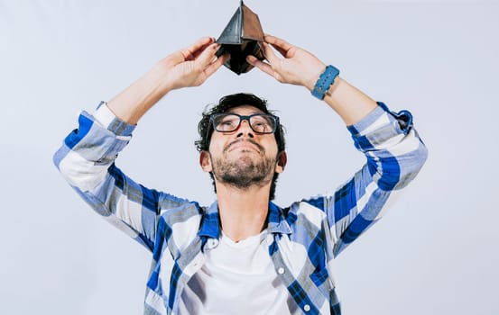 Sad man shaking an empty wallet. Sad person shaking an empty wallet. Man with financial problems shaking wallet. Moneyless frustrated person concept.