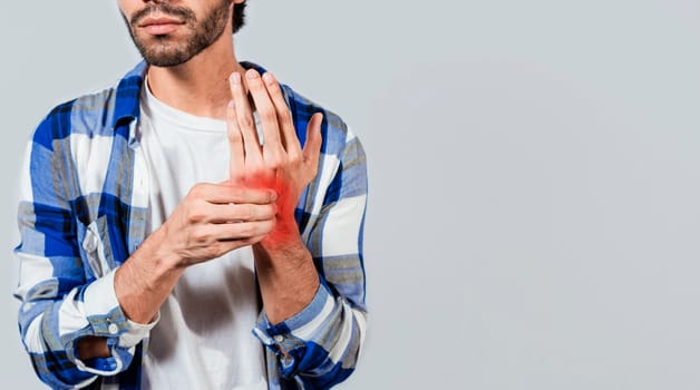 People with arthritis and hand pain, Man with pain in hands with copy space, Young suffering person with pain in hand joints. Man with arthritis rubbing his hands
