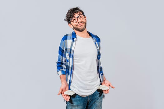 Sad man with no money showing his empty pockets, Unemployed people showing their empty pockets. Frustrated unemployed young man showing his empty pockets. Unemployed people concept