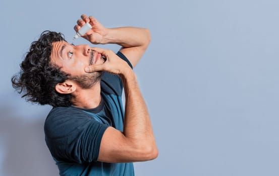 People applying refreshing drops to irritated eye. Man putting a dropper in his eye isolated. Man with irritated eye applying drops with a dropper, Person applying dropper to irritated eye