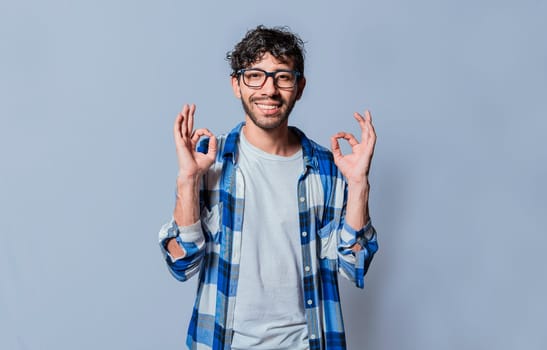 Smiling person gesturing OK in sign language, Interpreter man gesturing OK in sign language. Young man gesturing OK in sign language isolated. Manual gestures of people with hearing problems