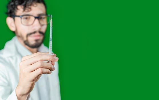 Close-up of a doctor's hand holding a syringe, Close-up of a hand holding an injection on an isolated background, Doctor and syringe concept
