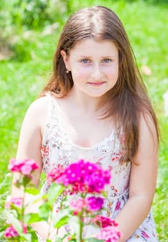 Portrait of a 10 year old girl enjoying the flower garden at home.