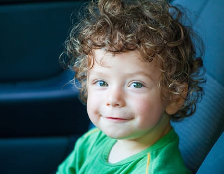 Portrait of 1 year old baby boy in the car.
