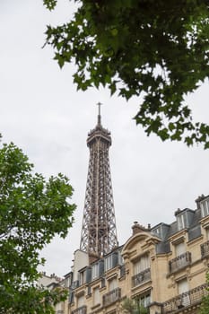 Eiffel Tower in Paris, France behind residential building.
