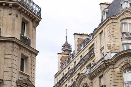 The Tip of the Eiffel Tower Hidden behind buildings.