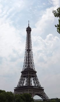 Eiffel Tower in Paris, France with clouds behind it.