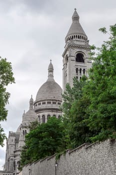 The  Sacre Coeur Church in Paris, France with trees in front of it.