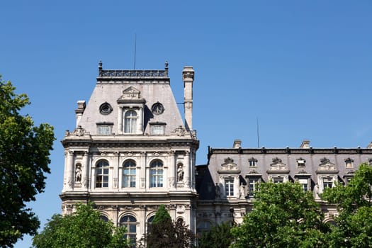 Buildings by the River Seine in Paris, France with a clear blue sky behind them.