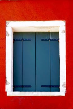 House Window with white frame in Burano on colorful wall building architecture, Venice, Italy