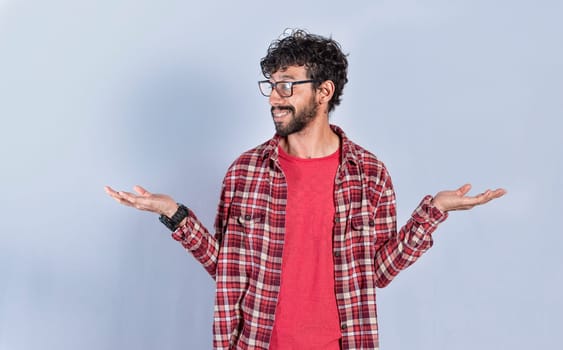 Young man balancing the palms of his hands ,Person comparing with the palms of his hands, a guy balancing the palms of his hands