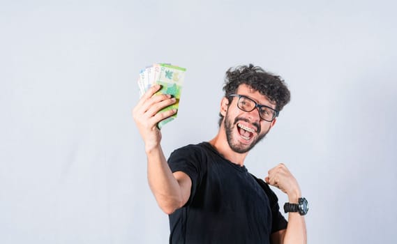 Happy person with money in hand, astonished man with banknotes in his hand, Excited person with money in his hand isolated.