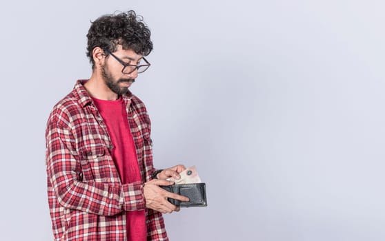 Portrait of man taking money out of his wallet, on isolated background, Person taking money out of his wallet on isolated background with copy space