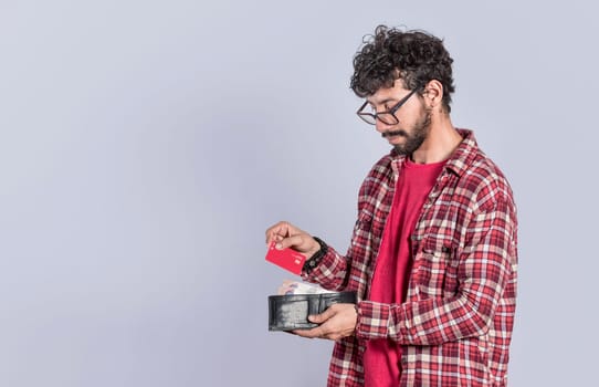 Person taking out credit card from his wallet, people taking out his debit card from his wallet on isolated background, concept of person paying with credit card with copy space
