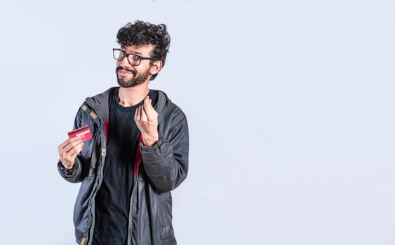 Handsome man with credit card making money gesture with fingers, Smiling person showing credit card making money gesture with fingers, Electronic payment concept