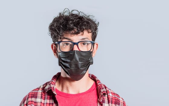 Close-up of person wearing surgical mask on isolated background, Close-up of handsome guy wearing protective mask, Close up of People in glasses wearing surgical mask isolated