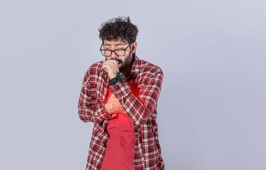 Young man with cough and chest pain, coughing on isolated background. man with pneumonia and bronchitis problems, concept of person with cough and pneumonia problems