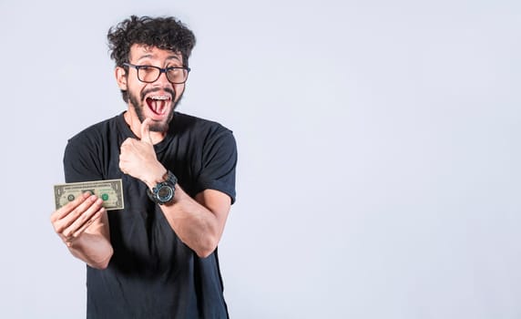 Happy man holding banknote in his hand, man with a banknote in his hand with thumb up, saving man concept, guy with money isolated