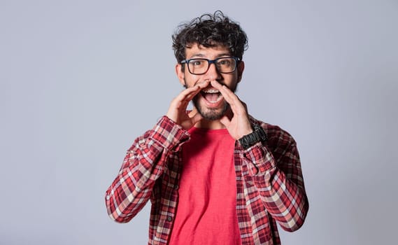 attractive man announcing with hands, friendly young man announcing from front, man announcing and yelling