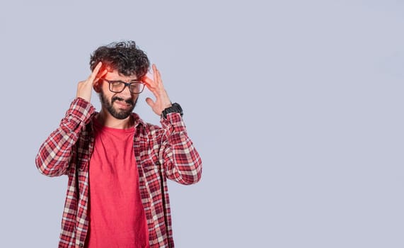 Concept of a man with a headache, man rubbing his head on isolated background, guy giving himself a head massage, concept of a man with a migraine