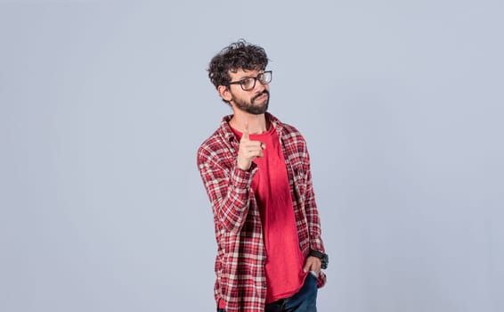 man pointing to the front with his finger, serious man pointing to the front on isolated background, a guy threatening with his finger