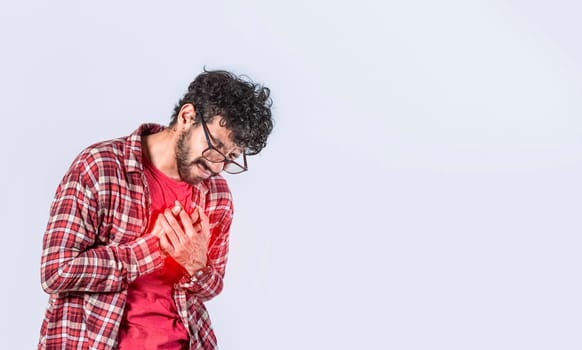 Man with heart pain on isolated background, man with chest pain isolated, man with tachycardia, young man with chest pain isolated