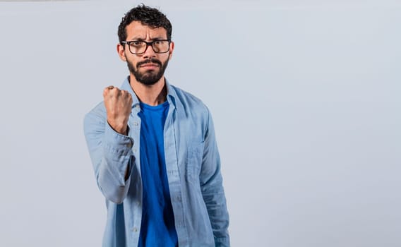 Angry glasses man, annoyed man showing his fist, angry man showing fist concept, aggressive person concept.