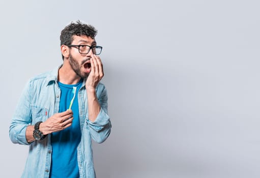 Person with brush with bad breath problem, Man with brush and bad breath, Concept of person with halitosis