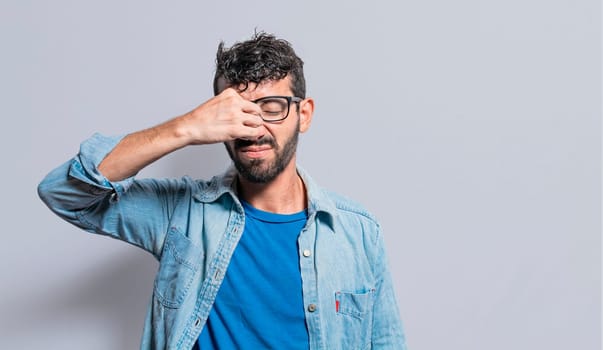 Person with pain touching nose. sinus pain concept, A person with nasal bridge pain, man with nasal bridge headache