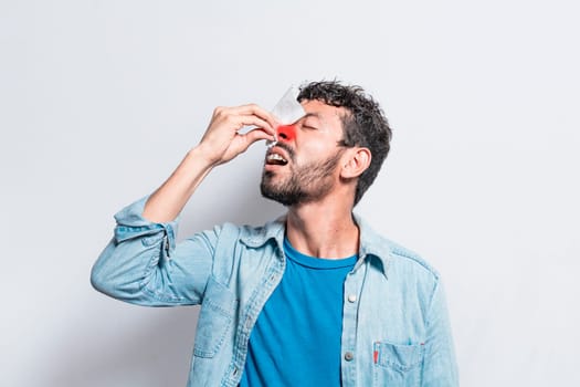 Person with irritated nose on isolated background, man with red nose cold, concept of person with sinusitis, Person with nasal congestion