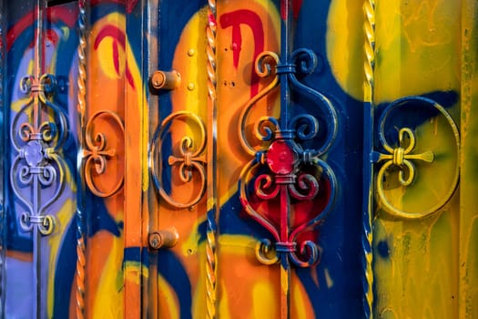 The door of the house smeared with the colors and paints of graffiti artists. Vibrant colors.