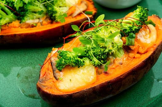 Baked sweet potato stuffed with mushrooms, broccoli and peppers. Healthy useful food
