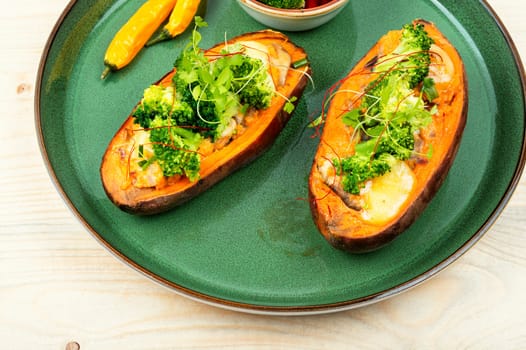Baked sweet potato stuffed with mushrooms, broccoli and peppers. Healthy useful food