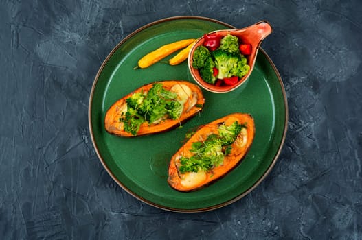 Baked sweet potato stuffed with mushrooms, broccoli and peppers. Healthy useful food