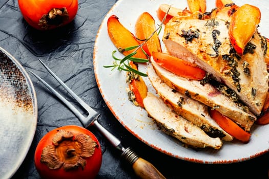 Chicken breast baked with persimmon on the plate. Healthy food